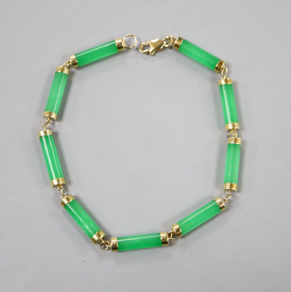 A 585 yellow metal mounted jadeite bracelet, 19cm, gross 6.6 grams.